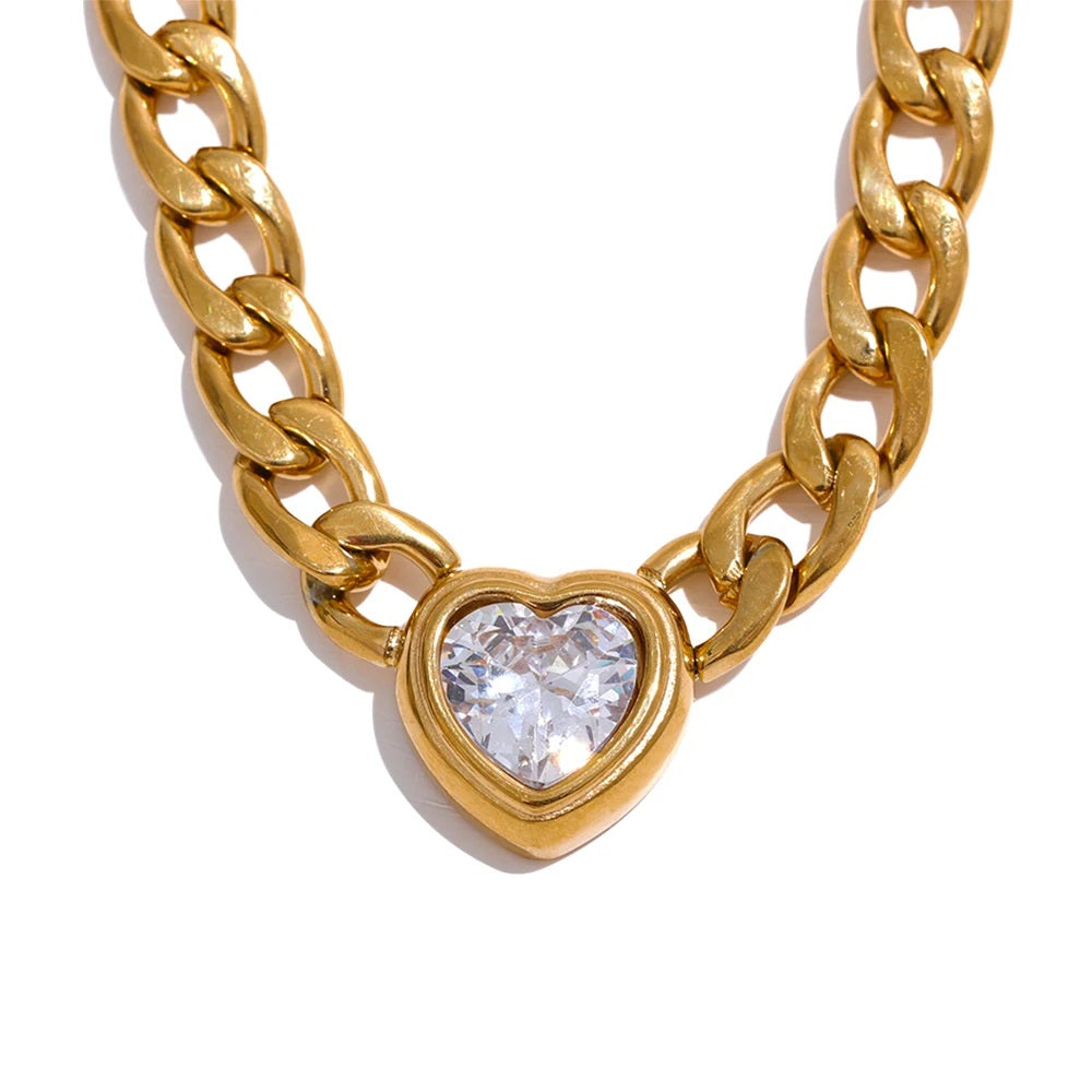 Chunky Heart Golden Necklace displayed on a white background, featuring a robust design with thick chains and a heart-shaped pendant, crafted from hypoallergenic stainless steel and plated with 18k gold, adorned with a zirconia heart pendant