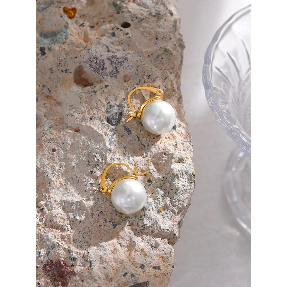 The Classic Mini Hoop Pearl Earrings combine timeless elegance with modern sophistication. Crafted from hypoallergenic stainless steel and plated with 18k gold, these mini hoops feature lustrous simulated pearls, offering a versatile and refined look for any occasion.