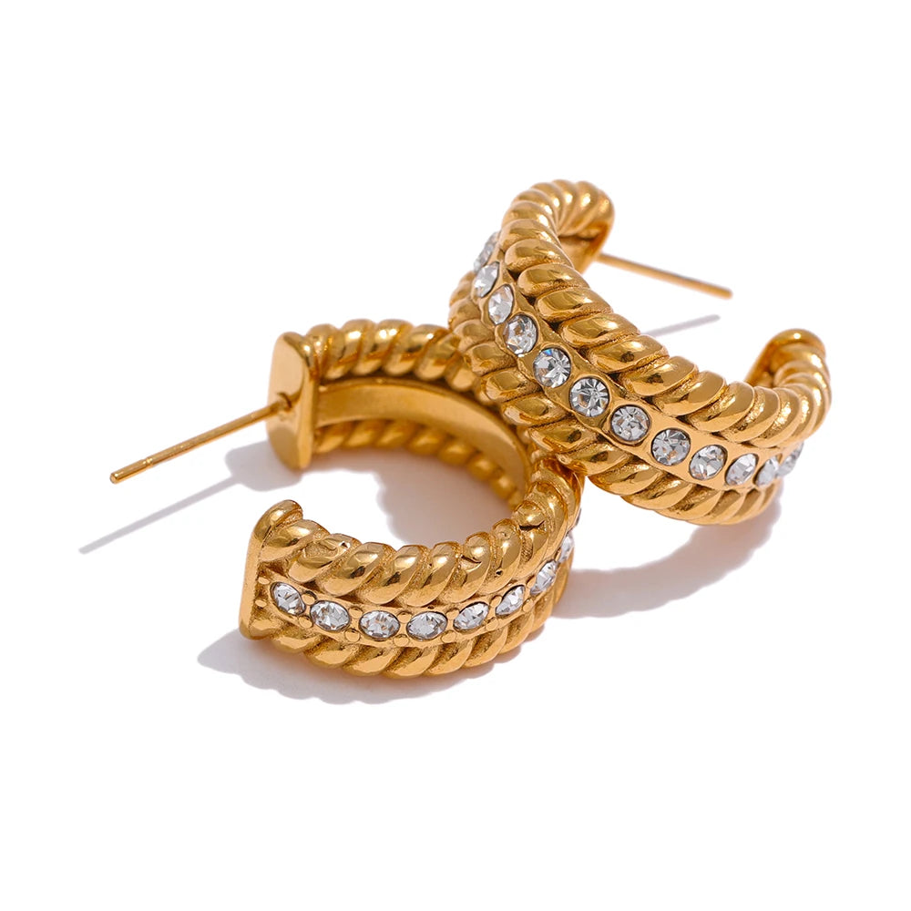 The C-Shaped Hoop earrings offer a modern and stylish look with their unique C-shaped design and sparkling zirconia embellishments. Crafted from hypoallergenic, eco-friendly stainless steel with a durable 18k gold plating, these earrings are both durable and sustainable, ideal for those who prioritize style and environmental consciousness.