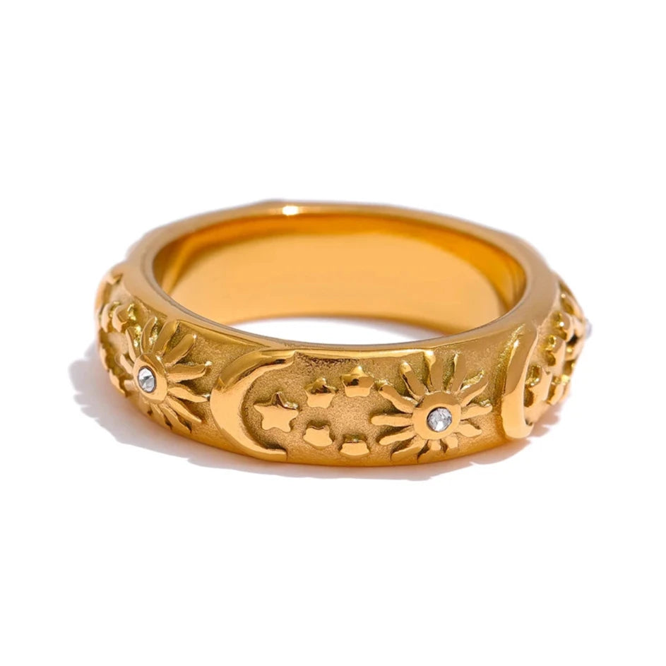 Celestial Ring - Cosmic Elegance. Crafted from hypoallergenic stainless steel, finished with durable 18k gold plating. Adorned with celestial designs symbolizing the sun, moon, and stars. Versatile and charming, designed for enduring comfort and style.