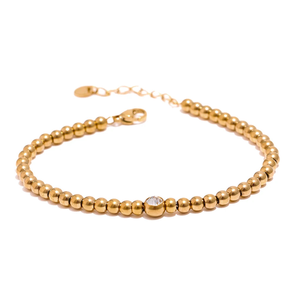 Golden Balls Chain Bracelet displayed on a white background, featuring multiple golden balls, crafted from hypoallergenic stainless steel and plated with 18k gold, adorned with certified moissanite