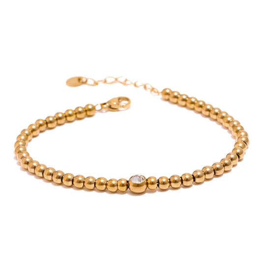 Golden Balls Chain Bracelet displayed on a white background, featuring multiple golden balls, crafted from hypoallergenic stainless steel and plated with 18k gold, adorned with certified moissanite