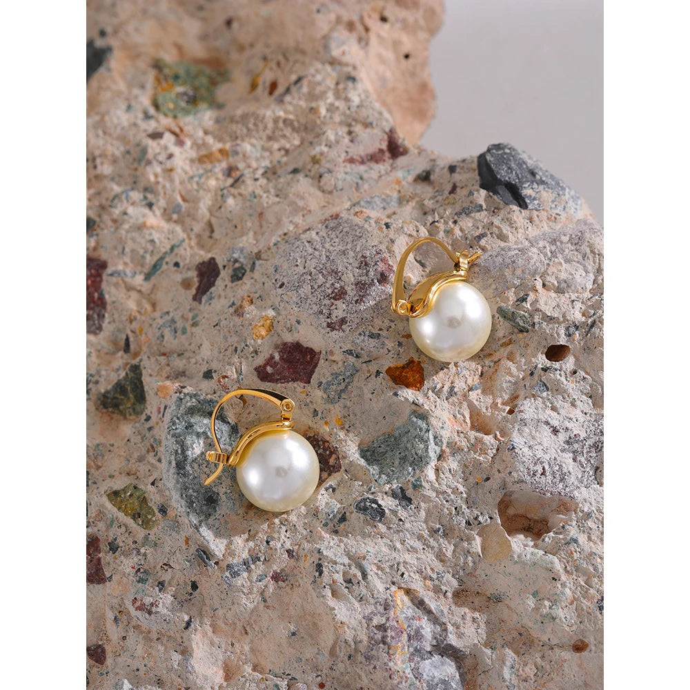 The Classic Mini Hoop Pearl Earrings combine timeless elegance with modern sophistication. Crafted from hypoallergenic stainless steel and plated with 18k gold, these mini hoops feature lustrous simulated pearls, offering a versatile and refined look for any occasion.