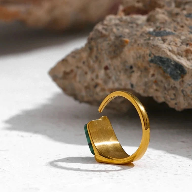 Admire the craftsmanship of our back of Vintage Verdant Ring. Crafted from hypoallergenic stainless steel and plated with 18k gold, it offers enduring elegance and an adjustable fit for any finger.