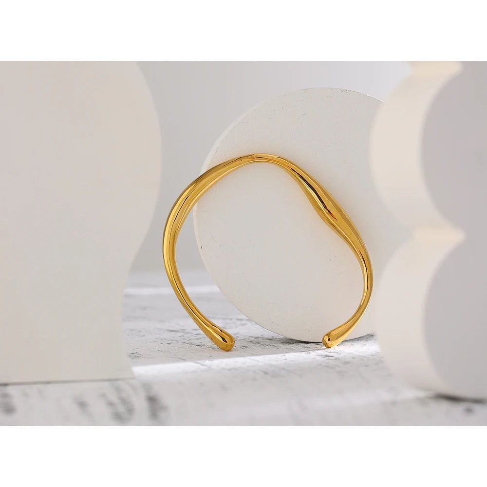 Minimalist Cuff Bracelet - Subtle Elegance. Crafted from hypoallergenic stainless steel, 18k gold plated, boasting a clean and sophisticated design. Versatile simplicity for enduring comfort and style.