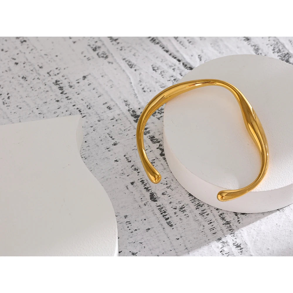 Minimalist Cuff Bracelet - Subtle Elegance. Crafted from hypoallergenic stainless steel, 18k gold plated, boasting a clean and sophisticated design. Versatile simplicity for enduring comfort and style.