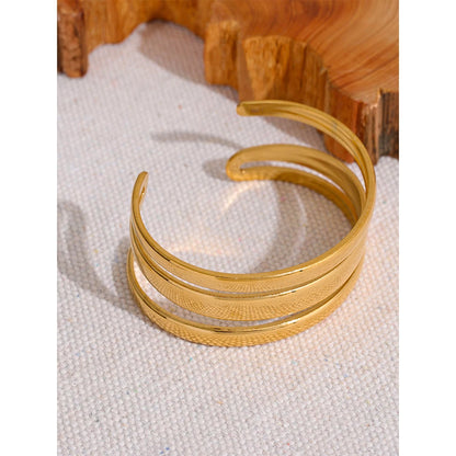 Triple Cuff Bracelet - Contemporary Sophistication. Crafted from hypoallergenic stainless steel with sustainable 18k gold plating. Versatile triple-sectioned design for elegant allure. Comfortable and enduring for all occasions.