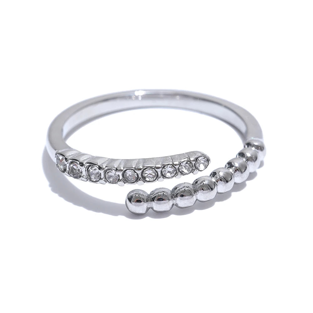 The Spheres and Zirconia Adorned Ring is displayed against a clean white background, highlighting its elegant design and sparkling zirconias.