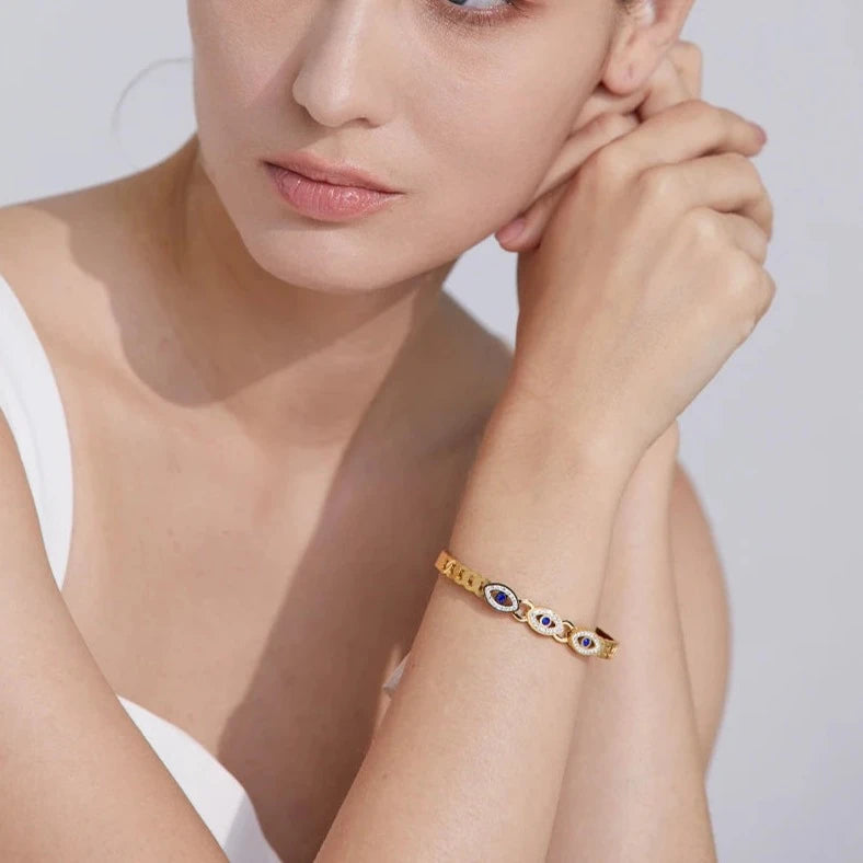 Elegant model wearing the Triple Greek Eye Protection Bracelet, highlighting the bracelet's combination of spiritual security and long-lasting comfort, crafted from hypoallergenic and sustainable materials