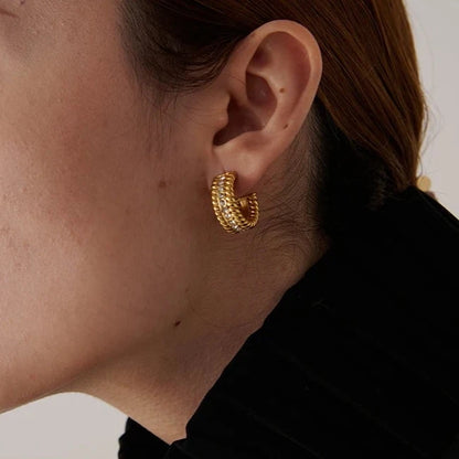 The C-Shaped Hoop earrings offer a modern and stylish look with their unique C-shaped design and sparkling zirconia embellishments. Crafted from hypoallergenic, eco-friendly stainless steel with a durable 18k gold plating, these earrings are both durable and sustainable, ideal for those who prioritize style and environmental consciousness.