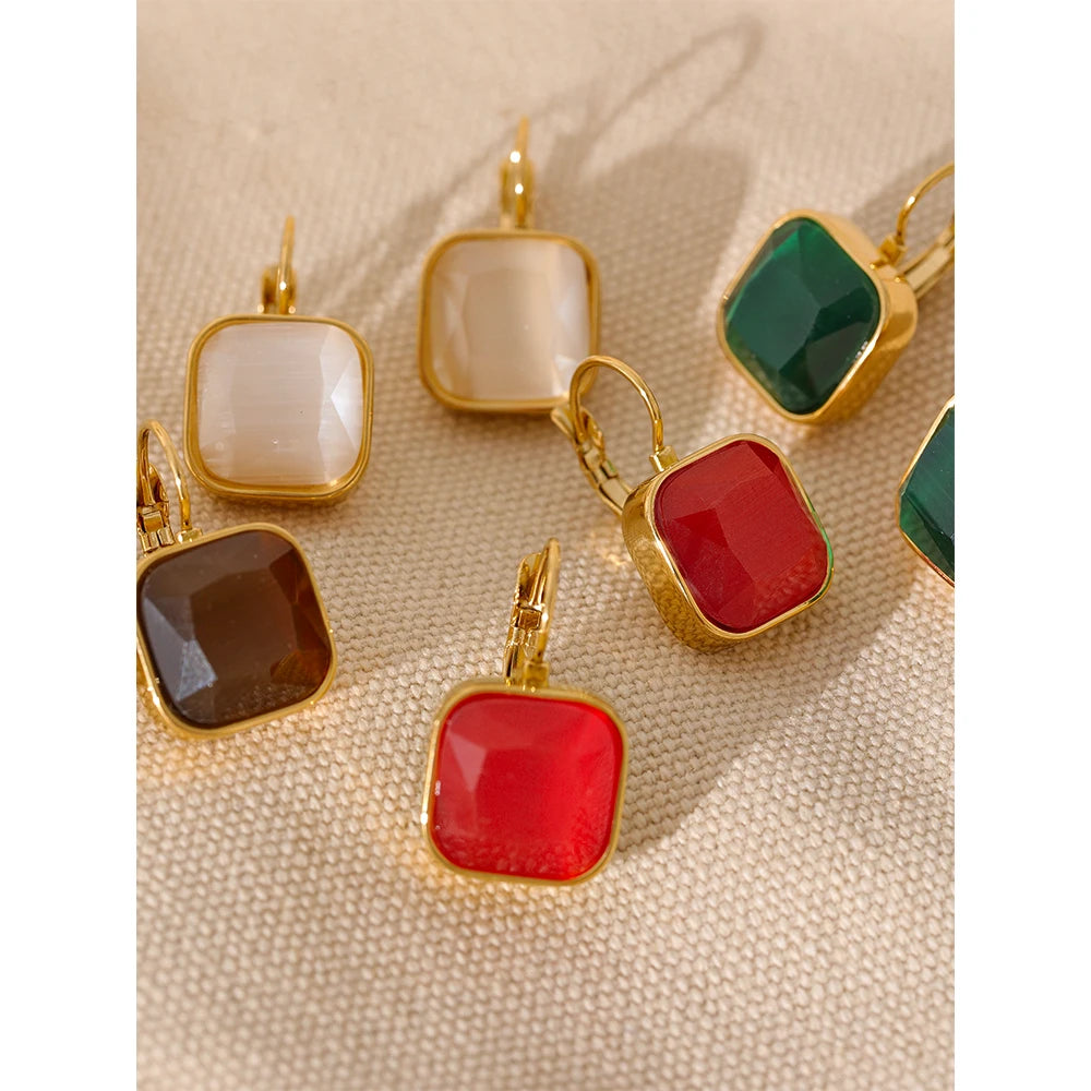 The Opal Square Stone Earrings exude ethereal beauty with opal stones skillfully cut to showcase a stunning array of colors. Crafted from hypoallergenic, eco-friendly stainless steel with a resilient, shiny 18k gold plating, they are perfect for adding mystical elegance to any outfit.