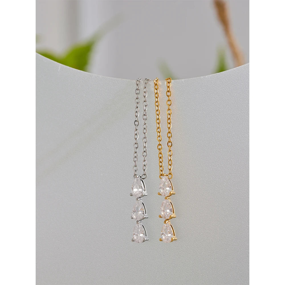 The Triple Zirconia Pendant Necklace combines modern elegance with glamour, featuring triple zirconia pendants on hypoallergenic, eco-friendly stainless steel, plated with durable 18k gold for a resilient shine.