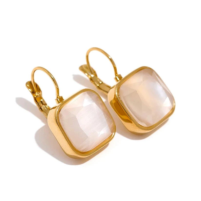 The Opal Square Stone Earrings exude ethereal beauty with opal stones skillfully cut to showcase a stunning array of colors. Crafted from hypoallergenic, eco-friendly stainless steel with a resilient, shiny 18k gold plating, they are perfect for adding mystical elegance to any outfit.