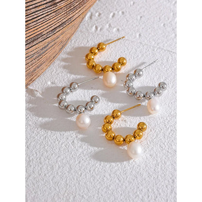 The Mini Sphere Hoop earrings with Pearl Dangle feature a charming contemporary design with small sphere hoops and delicate simulated pearls. Crafted from hypoallergenic, eco-friendly stainless steel with a durable 18k gold plating, they offer durability and sustainability for an elegant, conscious lifestyle.