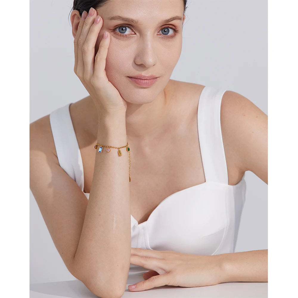 Model wearing the Radiant Rainbow Zirconia Bracelet, showcasing its dazzling brilliance and vibrant rainbow-like appearance, made from sustainable stainless steel with 18k gold plating