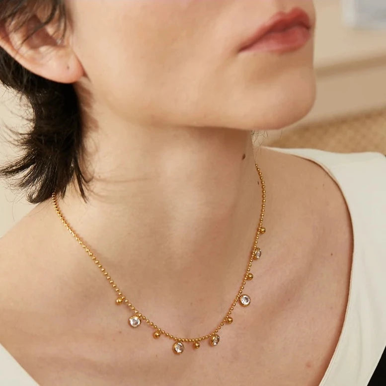 Elegant model wearing the Necklace with Spherical Pendants and Circular Zirconias, highlighting its elegant sophistication and lasting comfort, crafted from hypoallergenic stainless steel for all-day wear