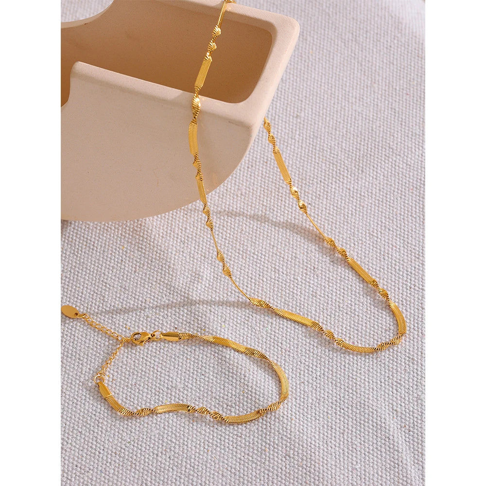 Elevate your style with our Flat Twisted Chain Necklace and Bracelet Set. Crafted from hypoallergenic stainless steel and plated with 18k gold, this set combines flat and twisted chains for an elegant and versatile look. Perfect for any occasion.