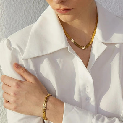 Stylish model showcasing the Basic Cuban Bracelet, demonstrating its elegance and versatility, featuring a chic Cuban design and sparkling cubic zirconias.