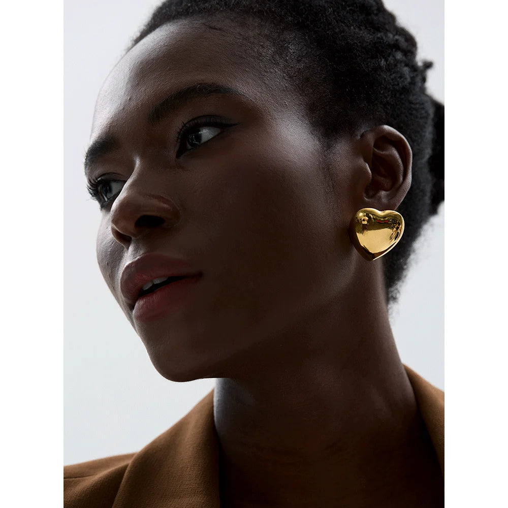 The Heart-Shaped Simple earrings feature a delicate heart-shaped design, expressing love and style with a minimalist aesthetic. Crafted from hypoallergenic stainless steel and plated with durable 18k gold, these earrings are sustainable and ideal for daily wear, adding elegance and meaning to any look.