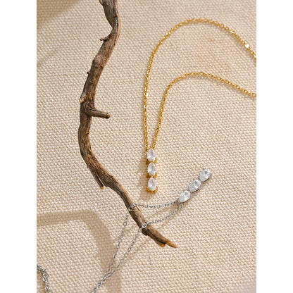 The Triple Zirconia Pendant Necklace combines modern elegance with glamour, featuring triple zirconia pendants on hypoallergenic, eco-friendly stainless steel, plated with durable 18k gold for a resilient shine.