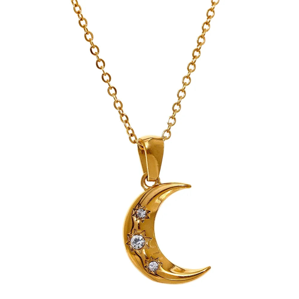 Lunar Glow Necklace - Celestial Charm. Crafted from hypoallergenic stainless steel, plated with 18k gold, featuring a moon-shaped pendant adorned with embedded zirconias. Sustainable and stylish.