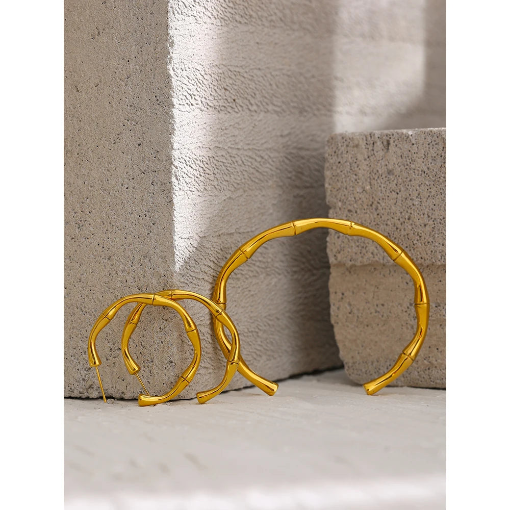 Elevate your style with our Golden Bamboo Cuff Bracelet, inspired by the elegance of bamboo. Crafted from hypoallergenic stainless steel with a sustainable 18k gold plating, its organic design adds natural sophistication to any ensemble.