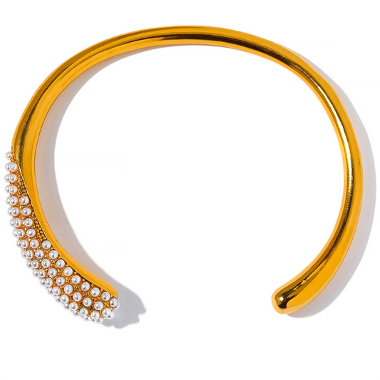  Elevate your elegance with our Pearl Accent Cuff Bracelet - Timeless Sophistication. Crafted from hypoallergenic stainless steel with sustainable 18k gold plating. Featuring simulated pearls for a touch of timeless elegance. Versatile design for all occasions.