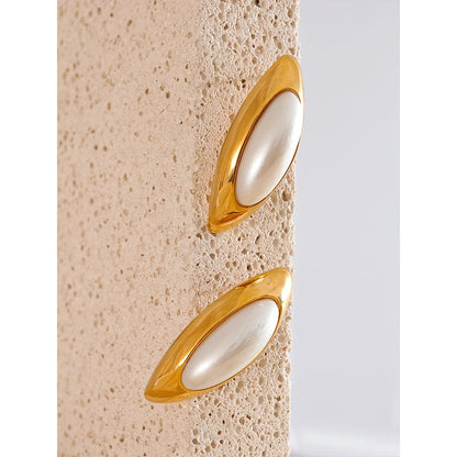 Discover elegance with our "Oval Simulated Pearl" earrings. Crafted from hypoallergenic stainless steel and plated with durable 18k gold, they feature simulated pearls in oval settings, adding a touch of sophistication to any look.