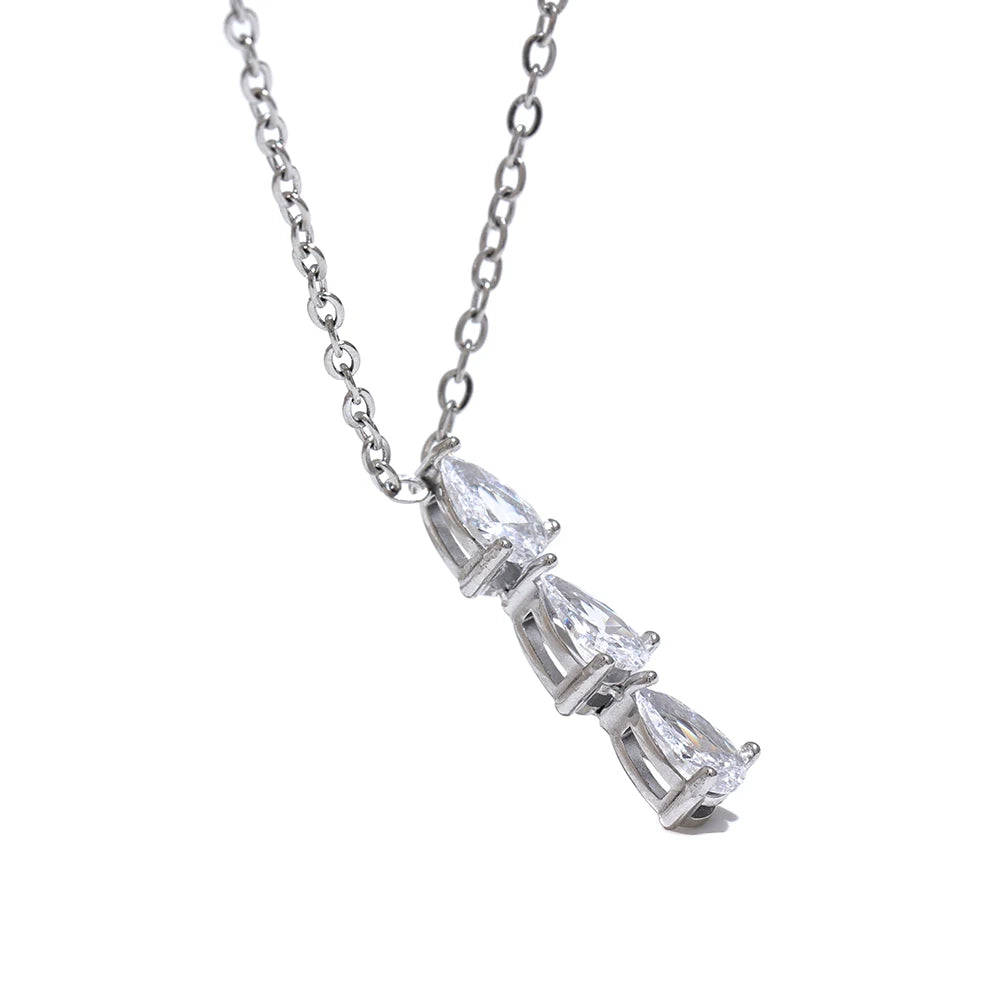 The Triple Zirconia Pendant Necklace combines modern elegance with glamour, featuring triple zirconia pendants on hypoallergenic, eco-friendly stainless steel, plated with durable 18k gold for a resilient shine.