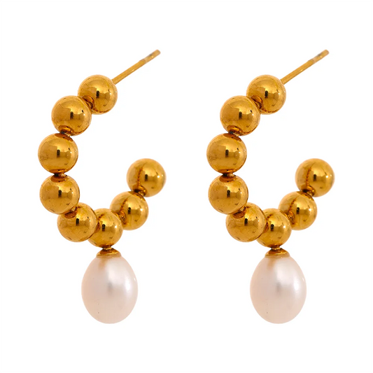 The Mini Sphere Hoop earrings with Pearl Dangle feature a charming contemporary design with small sphere hoops and delicate simulated pearls. Crafted from hypoallergenic, eco-friendly stainless steel with a durable 18k gold plating, they offer durability and sustainability for an elegant, conscious lifestyle.