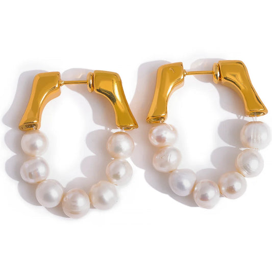 These exquisite earrings showcase a row of natural freshwater pearls, each selected for its exceptional quality, smooth iridescence, and luminous glow. Crafted from hypoallergenic stainless steel and plated with durable 18k gold, they embody elegance and luxury in every detail, reflecting light beautifully. Ideal for those seeking sophistication with a sustainable touch.