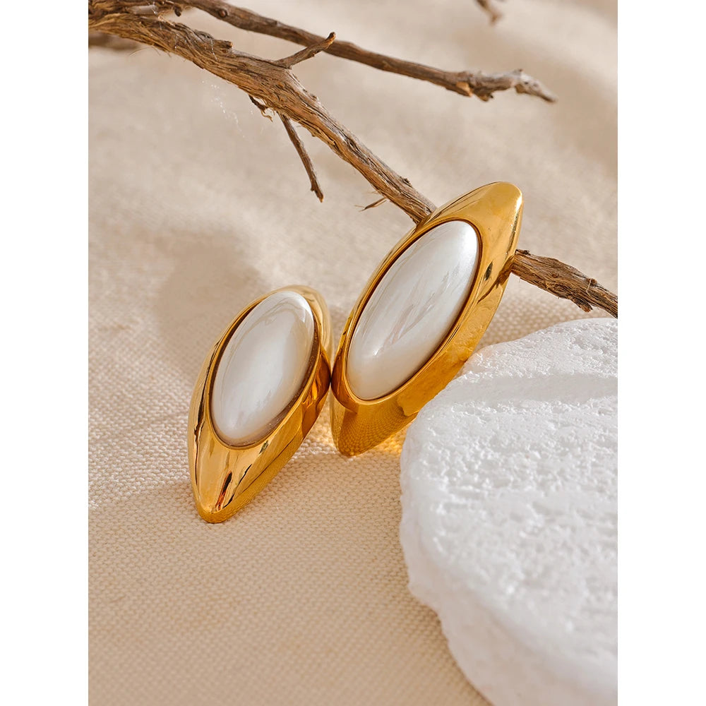 Discover elegance with our "Oval Simulated Pearl" earrings. Crafted from hypoallergenic stainless steel and plated with durable 18k gold, they feature simulated pearls in oval settings, adding a touch of sophistication to any look.