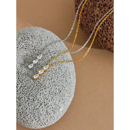 The Triple Zirconia Pendant Necklace combines modern elegance with glamour, featuring triple zirconia pendants on hypoallergenic, eco-friendly stainless steel, plated with durable 18k gold for a resilient shine.