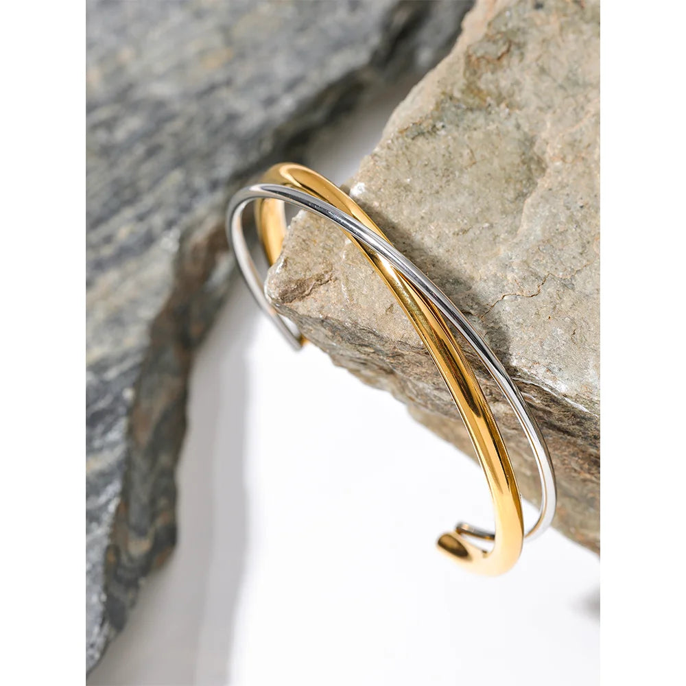 Double Color Cuff Bracelet - Contemporary Elegance. Crafted from hypoallergenic stainless steel, 18k gold plated, featuring dual silver and gold hues. Modern design for enduring elegance and comfort.