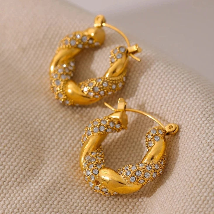 Close-up of the Gorgeous Twisted Hoop Earrings, highlighting the intricate twisted design and the radiant sparkle of the studded zirconias, crafted from hypoallergenic stainless steel with 18k gold plating