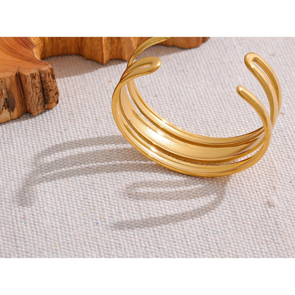 Triple Cuff Bracelet - Contemporary Sophistication. Crafted from hypoallergenic stainless steel with sustainable 18k gold plating. Versatile triple-sectioned design for elegant allure. Comfortable and enduring for all occasions.