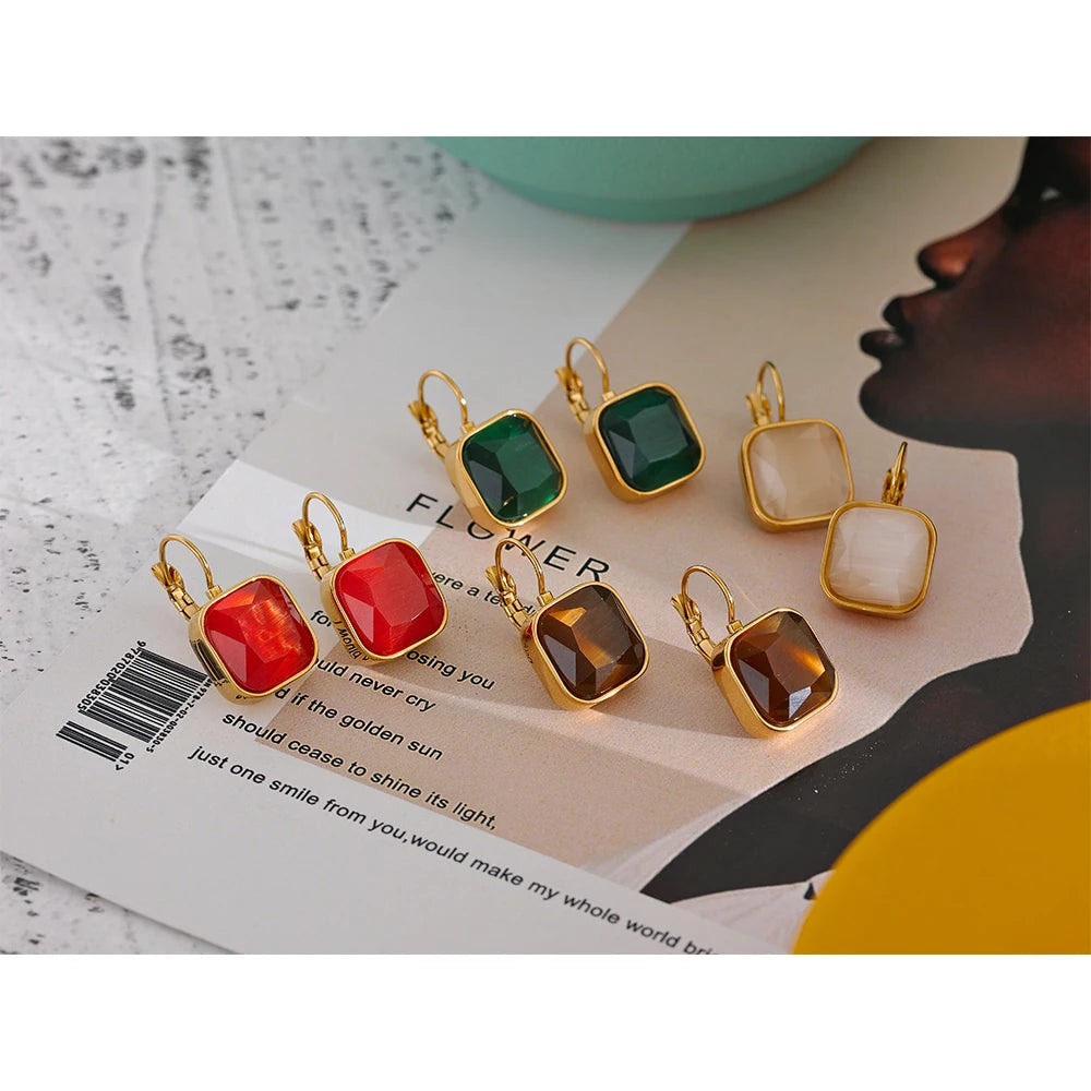 The Opal Square Stone Earrings exude ethereal beauty with opal stones skillfully cut to showcase a stunning array of colors. Crafted from hypoallergenic, eco-friendly stainless steel with a resilient, shiny 18k gold plating, they are perfect for adding mystical elegance to any outfit.