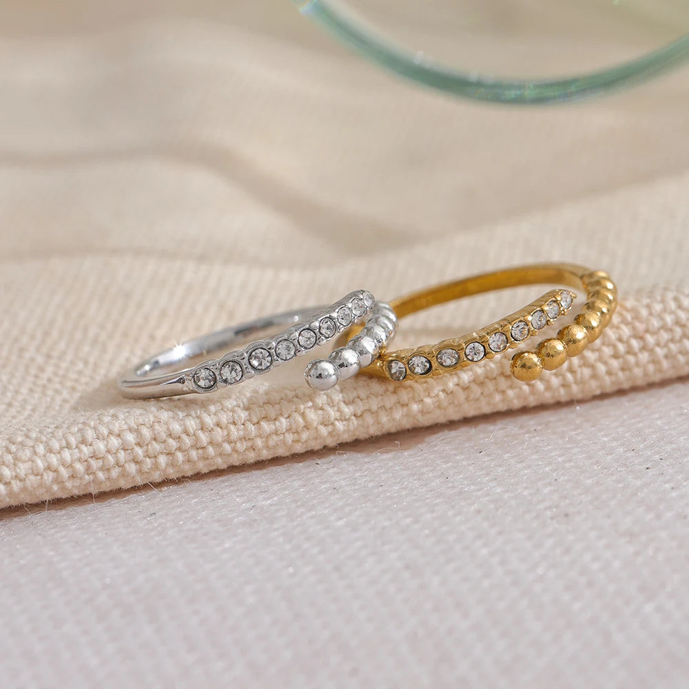 A close-up shot of the ring, focusing on the unique section of the band shaped like small spheres adorned with sparkling zirconias. This angle showcases the intricate details of the design, highlighting its distinctive charm.