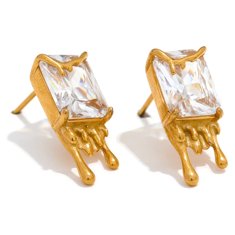 Flowing Gold Earrings displayed on a white background, showcasing their fluid and elegant design, crafted from hypoallergenic stainless steel and plated with 18k gold, adorned with cubic zirconias.