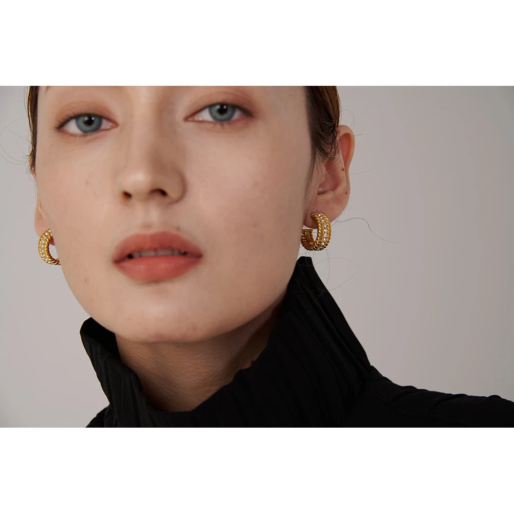 The C-Shaped Hoop earrings offer a modern and stylish look with their unique C-shaped design and sparkling zirconia embellishments. Crafted from hypoallergenic, eco-friendly stainless steel with a durable 18k gold plating, these earrings are both durable and sustainable, ideal for those who prioritize style and environmental consciousness.