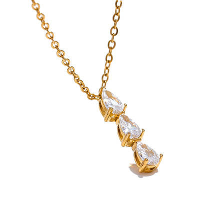 The Triple Zirconia Pendant Necklace combines modern elegance with glamour, featuring triple zirconia pendants on hypoallergenic, eco-friendly stainless steel, plated with durable 18k gold for a resilient shine.